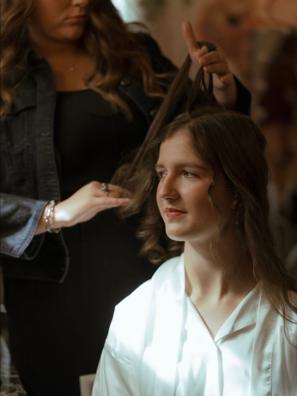 Hannah sectioning a client's hair