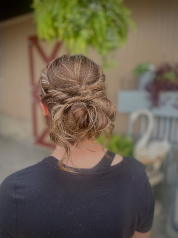 Twisted low bun in a barn by Hannah