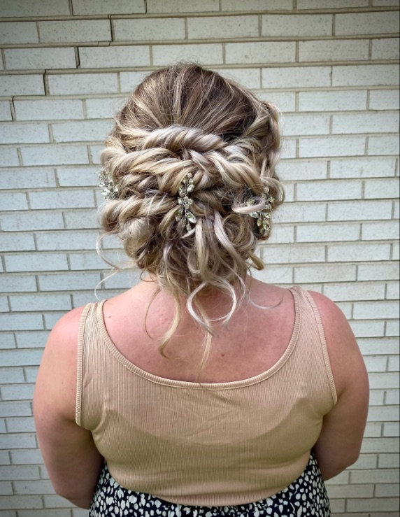 Twisted blonde updo with jeweled pins, from behind