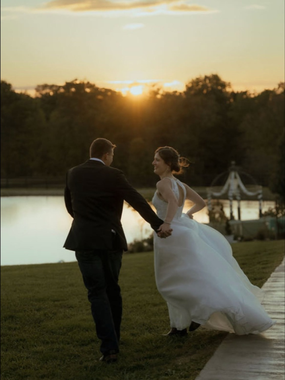 A couple running at sunset after their wedding